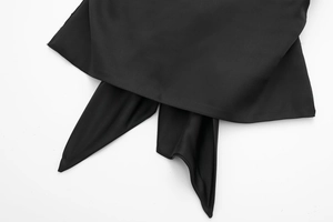 Detail of black satin fabric showing premium texture and cross-tie ribbon design