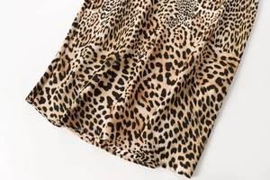 Close-up of leopard print chiffon fabric texture showing detailed spots and elegant drape