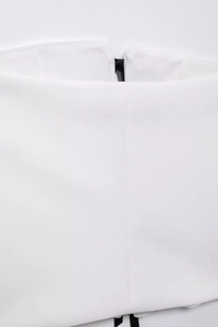 Detailed macro view of high-density white fabric and hidden zipper closure on the summer top