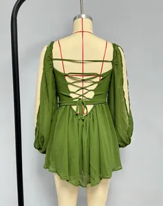 Detail of cross back lace-up design on grass green chiffon dress with lantern sleeves