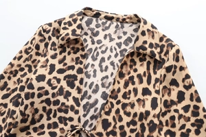 Detail of leopard print shirt with V-neckline, lapel collar and delicate tie string