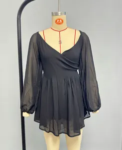 Detail of elegant black V-neck chiffon dress with lantern sleeves and layered pleated skirt