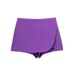 Detail of high-waist purple skort featuring an asymmetric wrap front and side zipper