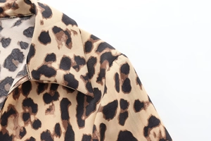 Detail shot of leopard print satin shirt showing classic lapel collar and shoulder seams