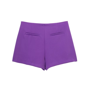 Detail view of purple high-waisted shorts featuring symmetrical decorative back welt pockets