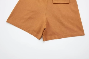 Detailed macro view of linen-blend shorts with flap pocket design and premium stitching