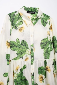 Detail of floral print shirt with green leaves, yellow flowers and white buttons