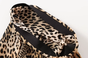 Close-up of leopard print midi skirt featuring a high-elastic black waistband