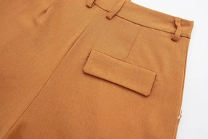 Detail view of the caramel linen blend trousers featuring back pocket flap and belt loops