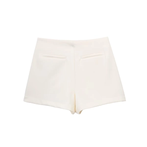 Detail view of the back pockets and tailored stitching on white asymmetric shorts