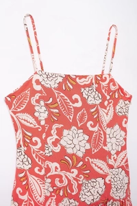 Detail of floral printed camisole dress featuring thin straps and hidden side zipper