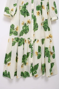 Detail of floral print pattern on off-white long-sleeve dress with buttoned front