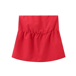 Detail of red tube top featuring elastic shirred fabric and smooth polyester texture
