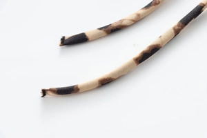 Close-up of leopard print satin ribbons with detailed texture and brown pattern