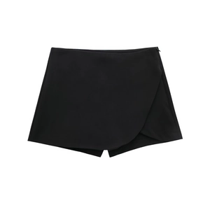 Detail of high waist black asymmetrical skort showing smooth fabric and invisible zipper