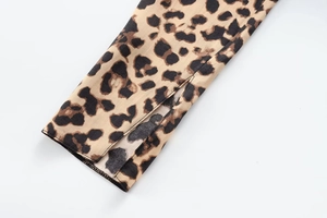 Close-up of leopard print satin fabric showing the slit cuff detail and fine stitching