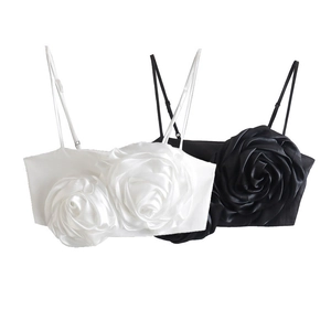 Detail of elegant 3D floral applique on satin cropped top with thin shoulder straps
