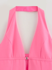 Close-up of a vibrant neon pink halter top featuring a deep V-neck and silver metal buckle