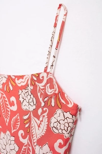 Detail view of red floral printed dress showing side invisible zipper and fabric texture