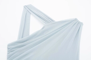 Detailed close-up of light blue mesh fabric with asymmetric pleated layers and draped texture