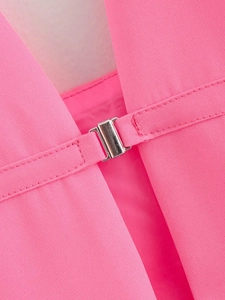 Close-up of silver metal buckle on vibrant pink fabric for women's halter vest