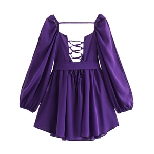 Detail of purple V-neck dress featuring back hollow-out cross lace-up and puff sleeves
