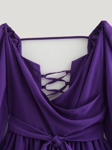 Detailed back view of purple V-neck dress featuring lace-up design and waist tie