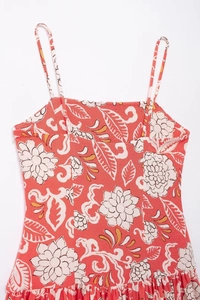 Detailed close-up of floral print sundress featuring orange petals and hidden side zipper