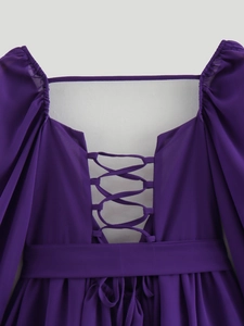 Detail of purple chiffon dress with puffy sleeves and lace-up crisscross back tie