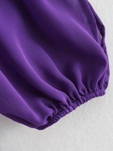 Detailed macro view of the purple chiffon dress sleeve featuring elastic ruffled cuffs
