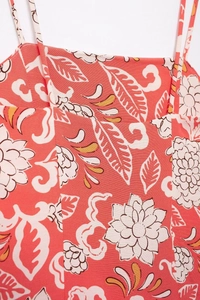 Detailed view of floral print on coral cotton-linen dress with thin shoulder straps
