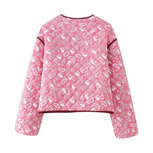 Detail of pink paisley quilted jacket featuring contrast red trim and diamond patterns