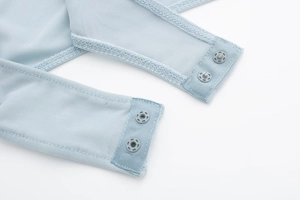 Detail of light blue mesh bodysuit featuring snap buttons at the crotch for easy wear