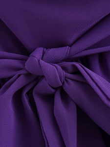 Macro view of dark purple chiffon dress showing elegant tie-knot waist detail and soft texture