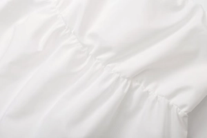 Close-up of ruched detail and soft pleat texture on a white slim fit tube top