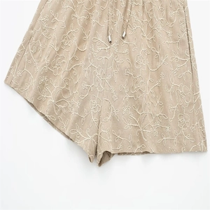 Beige summer shorts with white floral embroidery and elastic drawstring waistband