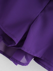 Detail of fine hemline stitching and double-layered purple chiffon fabric on V-neck dress