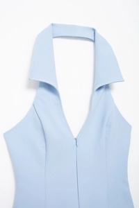 Detailed view of light blue halter neck top with shirt collar and front zipper detail