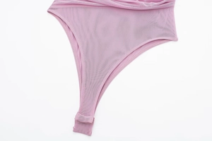 Detailed macro view of mesh bodysuit crotch featuring snap button closure and fine stitching