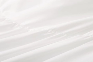 Close-up of white ruched fabric texture showing detailed pleated cotton material on top