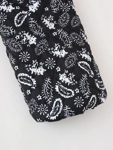 Detail of black and white floral quilted fabric with intricate botanical patterns