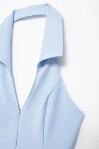 Close-up of light blue halter top featuring a V-neckline and invisible zipper detail