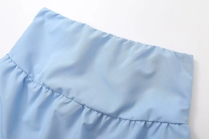 Detailed macro view of the light blue elastic waistband showing fine fabric texture and pleats