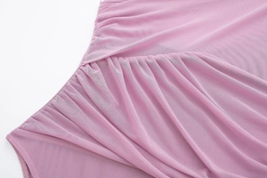 Detail of pink mesh fabric with soft ruched pleats and delicate translucent texture