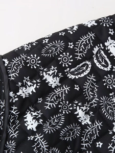 Detail shot of black floral quilted fabric texture with refined black edge piping