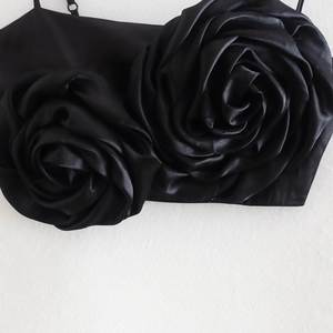 Women's black satin camisole top featuring large 3D rose floral decorations and stand collar