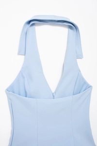Detailed view of light blue halter neck top featuring a deep V-neck and front zipper detail