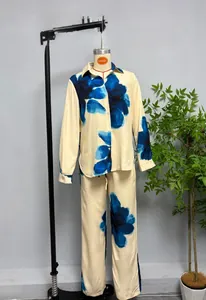 Detail of floral loungewear set featuring long-sleeve shirt and straight pants in silk texture
