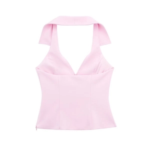 Detail of pink halter neck vest featuring lapel collar, V-neckline and side zipper