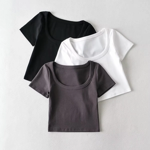 Detailed flat lay of slim fit crop tops in black, white, and grey with U-neck design